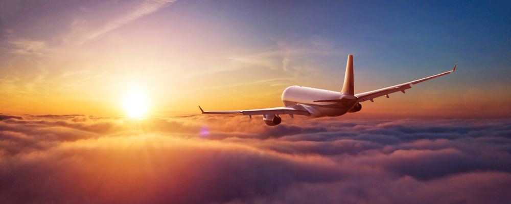 Passengers,Commercial,Airplane,Flying,Above,Clouds,In,Sunset,Light.,Concept