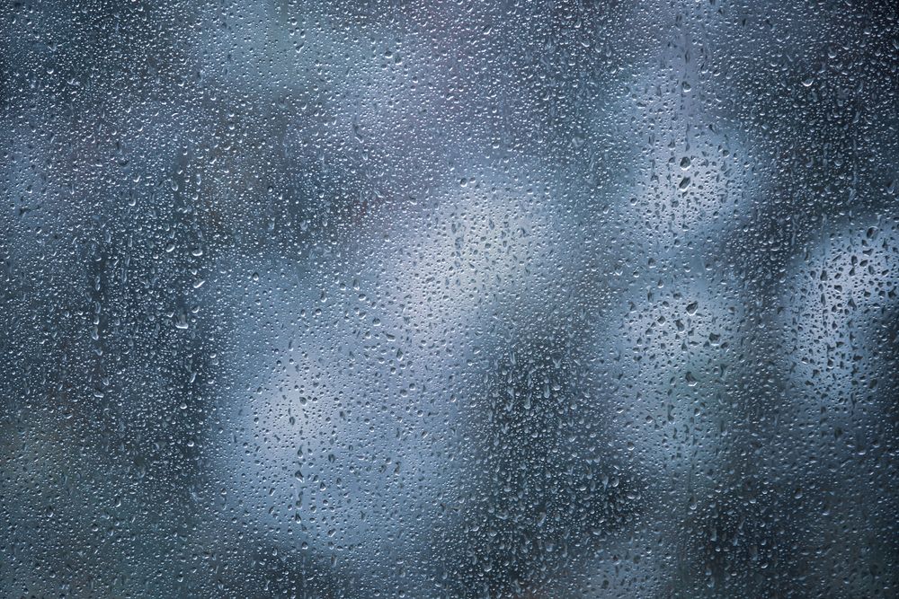 Raindrops,On,Glass,Of,Window,With,Dark,Green,Nature,Blurred