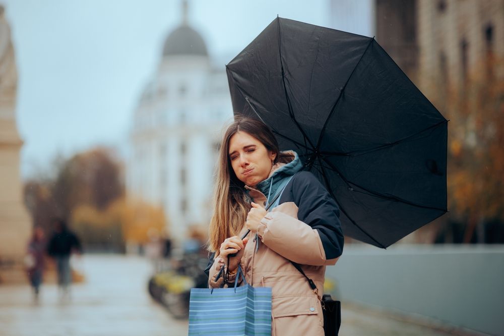 Stressed,Woman,Walking,In,The,Rain,With,Broken,Umbrella,Girl