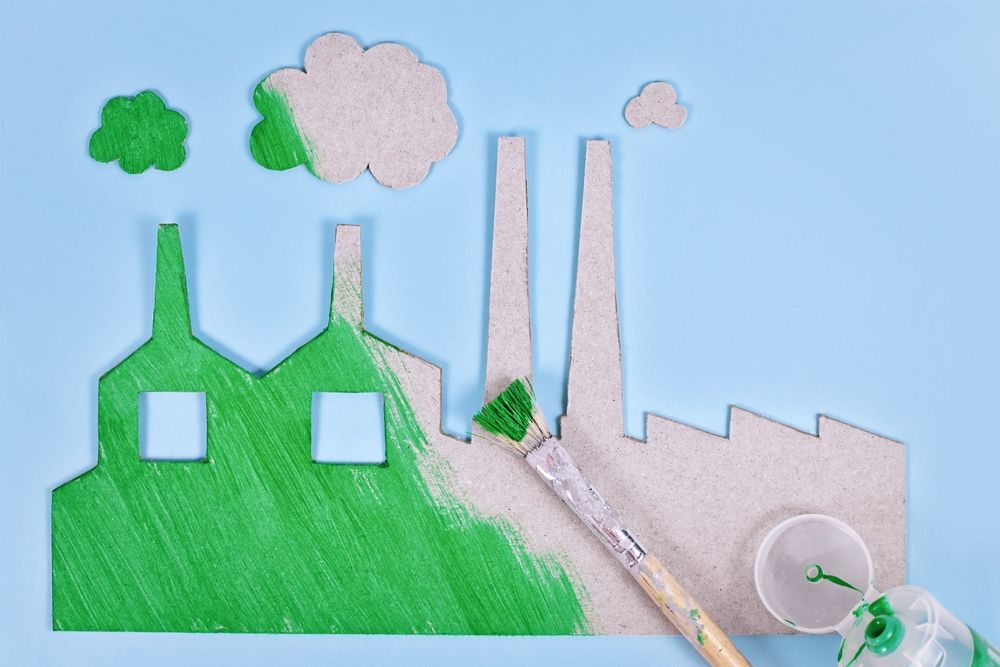 Greenwashing,Concept,With,Cardboard,Factory,Being,Painted,Green