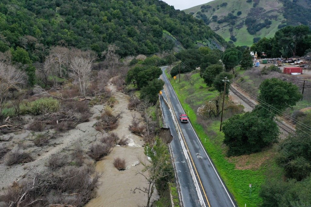 Part of canyon road collapses into creek in California due to atmospheric river storm