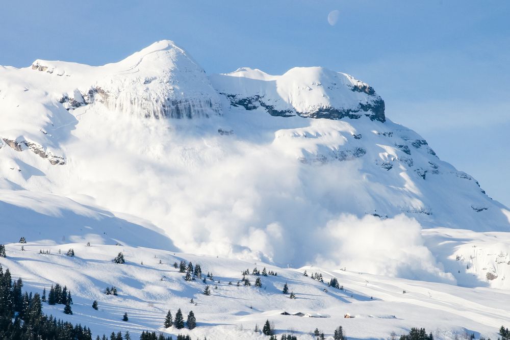 Huge,Real,Avalanche,In,The,French,Alps,With,The,Moon