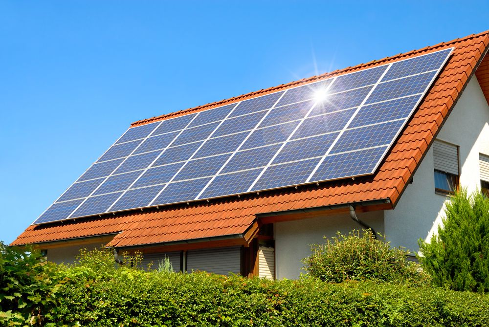 Solar,Panel,On,A,Red,Roof,Reflecting,The,Sun,And