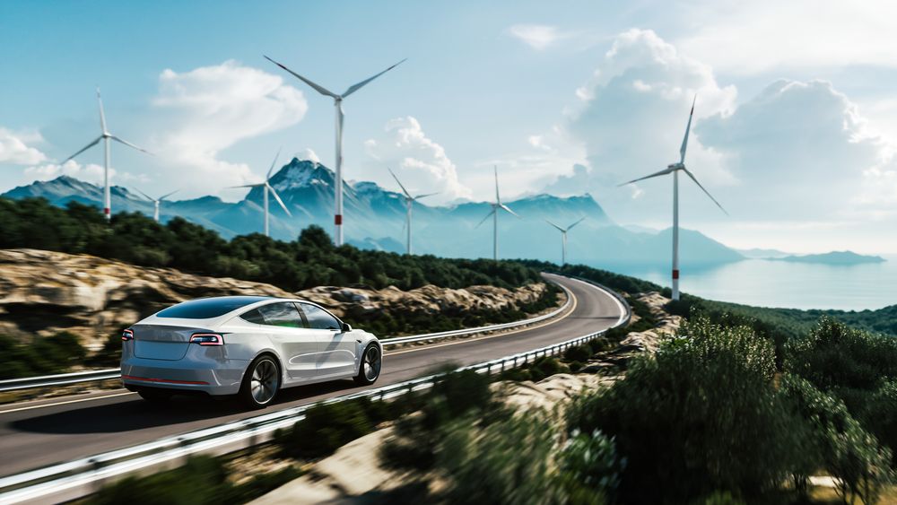 Electric,Car,Drive,On,The,Wind,Turbines,Background.,Car,Drives