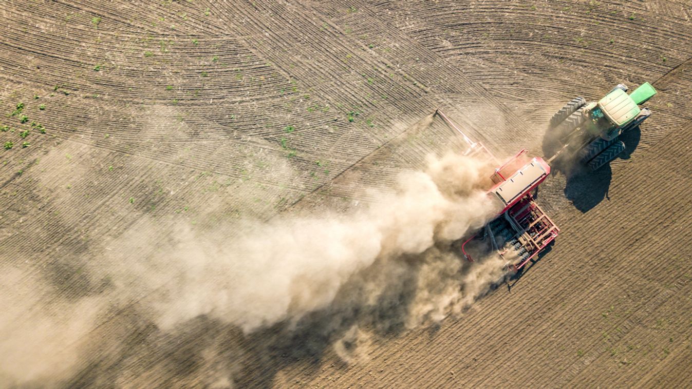 Top,Down,Aerial,View,Of,Green,Tractor,Cultivating,Ground,And