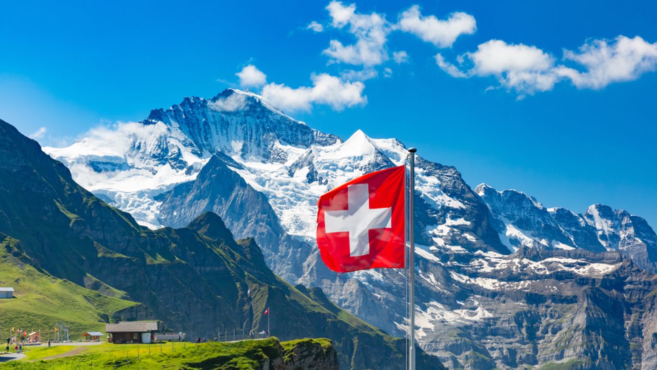 Swiss,Flag,Waving,And,Tourists,Admire,The,Peaks,Of,Monch