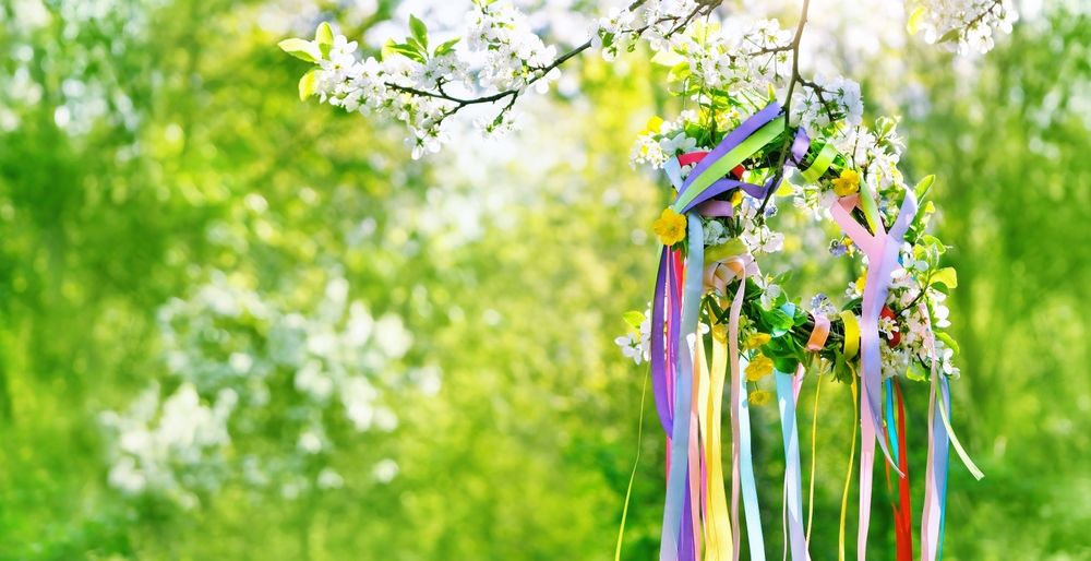 Spring,Floral,Wreath,With,Colorful,Ribbons,On,Tree,In,Garden,