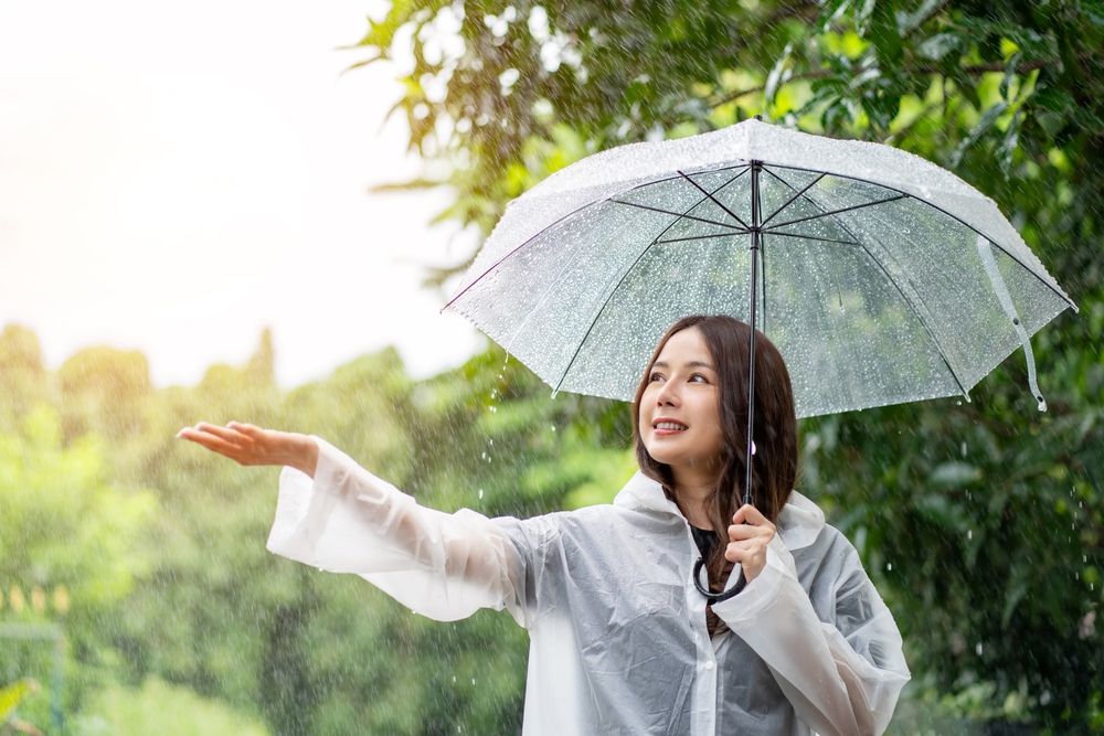 Woman,Holding,An,Umbrella,While,It,Rains.