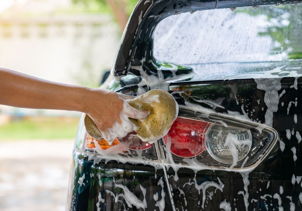 Woman,Washing,Car,Tail,Lights,With,Shampoo,At,Home.,Car