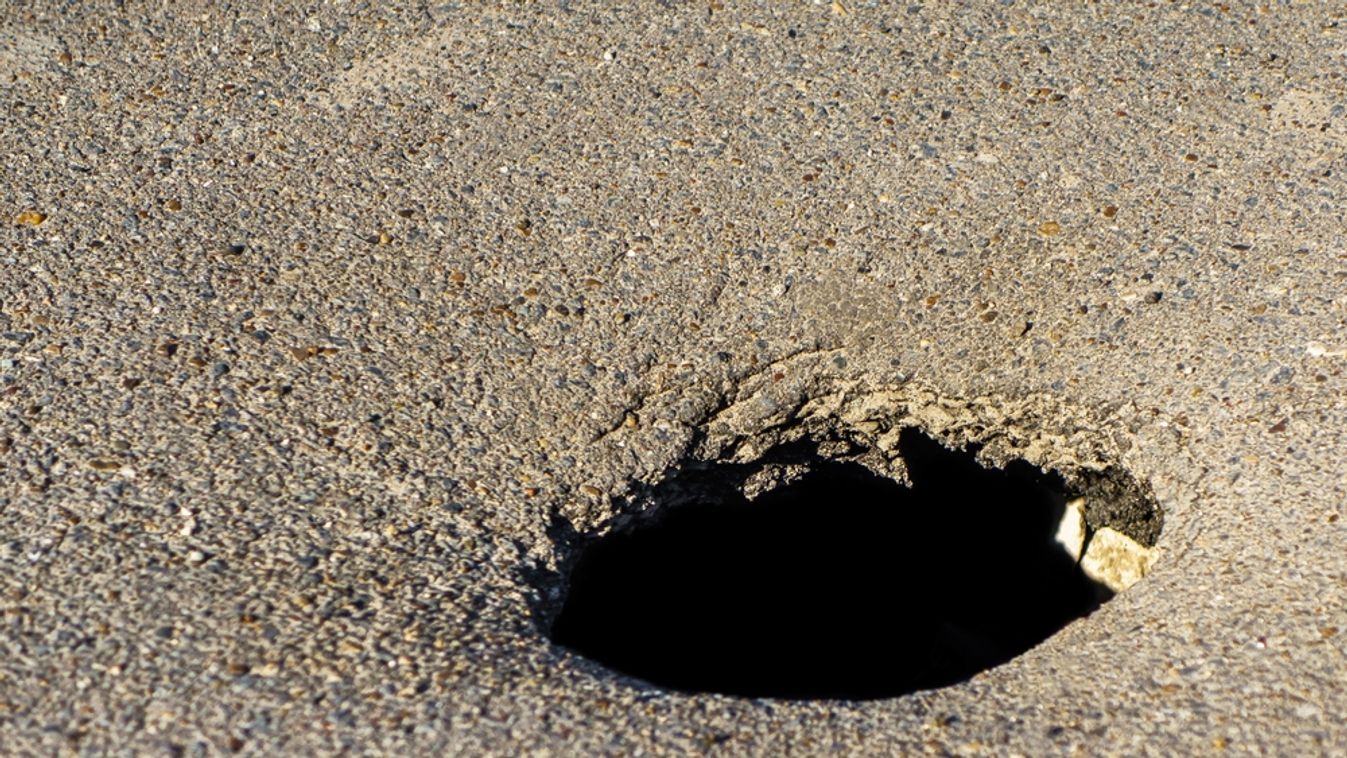 Circular,Hole,In,The,Asphalt,Caused,By,Groundwater,Flooding,Or