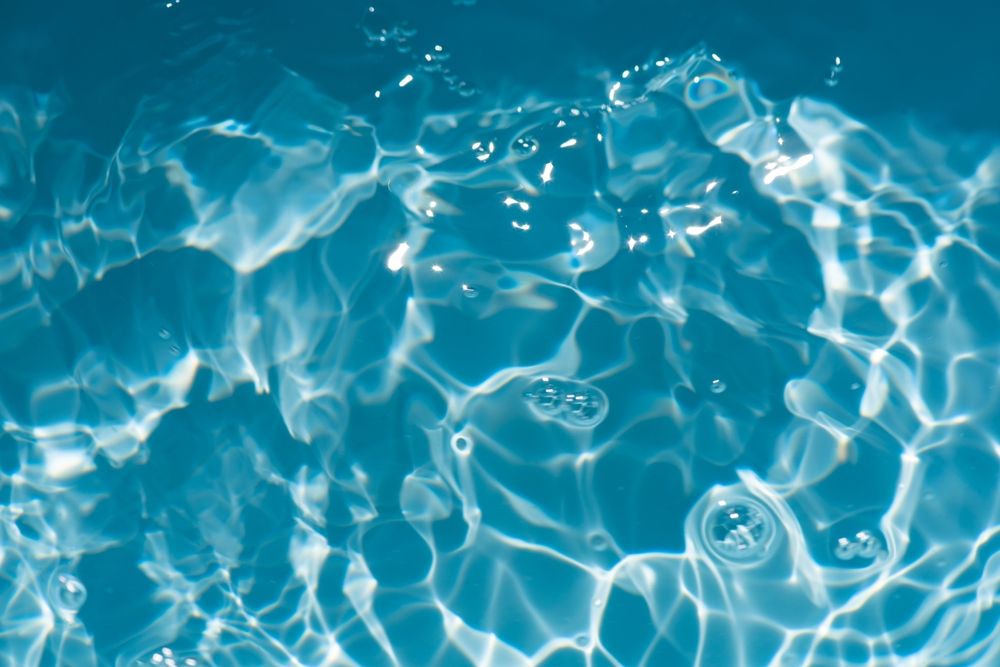 Blue,Water,With,Ripples,On,The,Surface.,Defocus,Blurred,Transparent