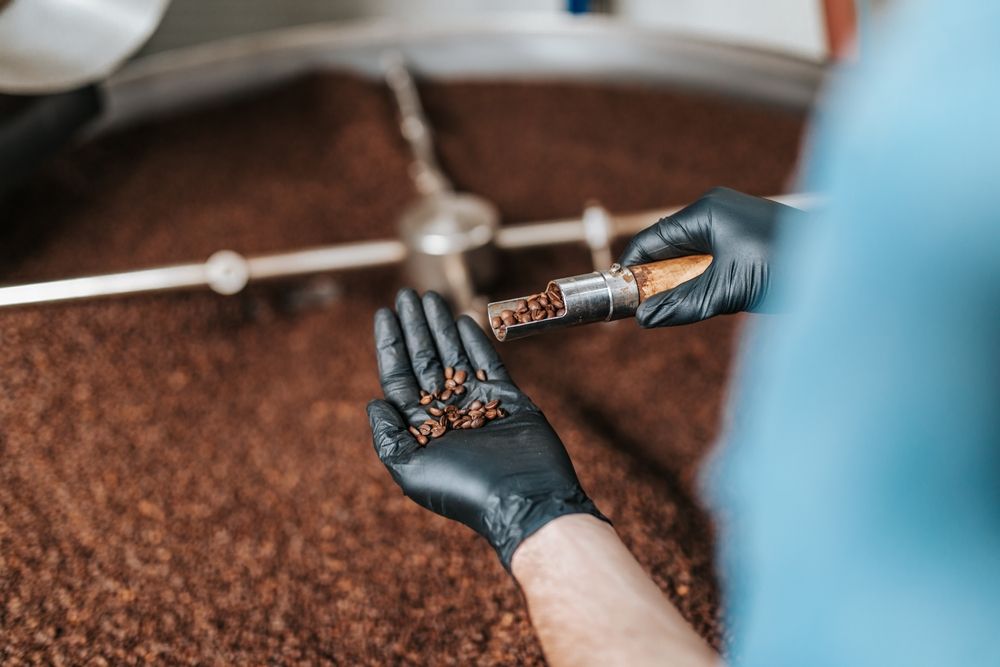 Man's,Hands,Holding,Freshly,Roasted,Aromatic,Coffee,Beans,Over,A