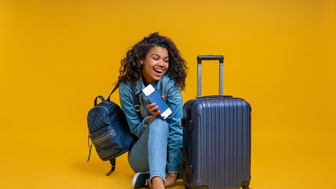 Beautiful,Excited,Girl,Turist,Sitting,On,The,Floor,With,Passport