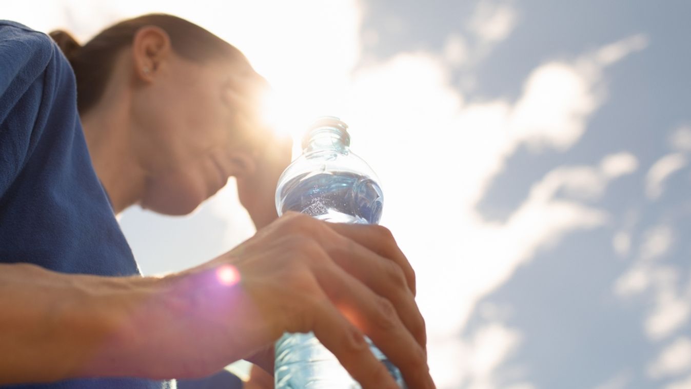 Woman,Drinking,Water,Cooling,Off,In,Extreme,Summer,Heat,Wave,